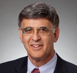 Middle-aged man with short gray hair, glasses, and a suit jacket over a striped shirt and tie, smiling at the camera against a neutral background—professional look typical of lawyers in Chicago or a corporate law office.