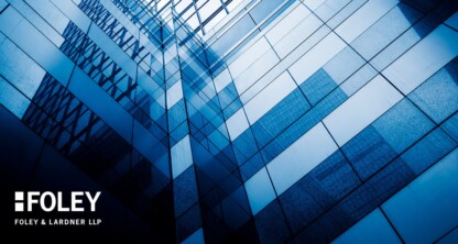 Abstract geometric view of a modern glass building exterior with blue tint, featuring the Foley & Lardner LLP logo in the lower left corner, representing a leading corporate law office and lawyers in Chicago.