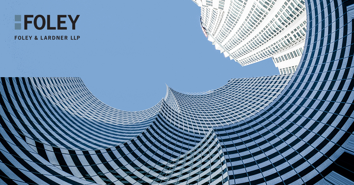 Looking up at modern curved glass skyscrapers against a blue sky, with the Foley & Lardner LLP logo in the top left corner, representing premier Chicago lawyers.