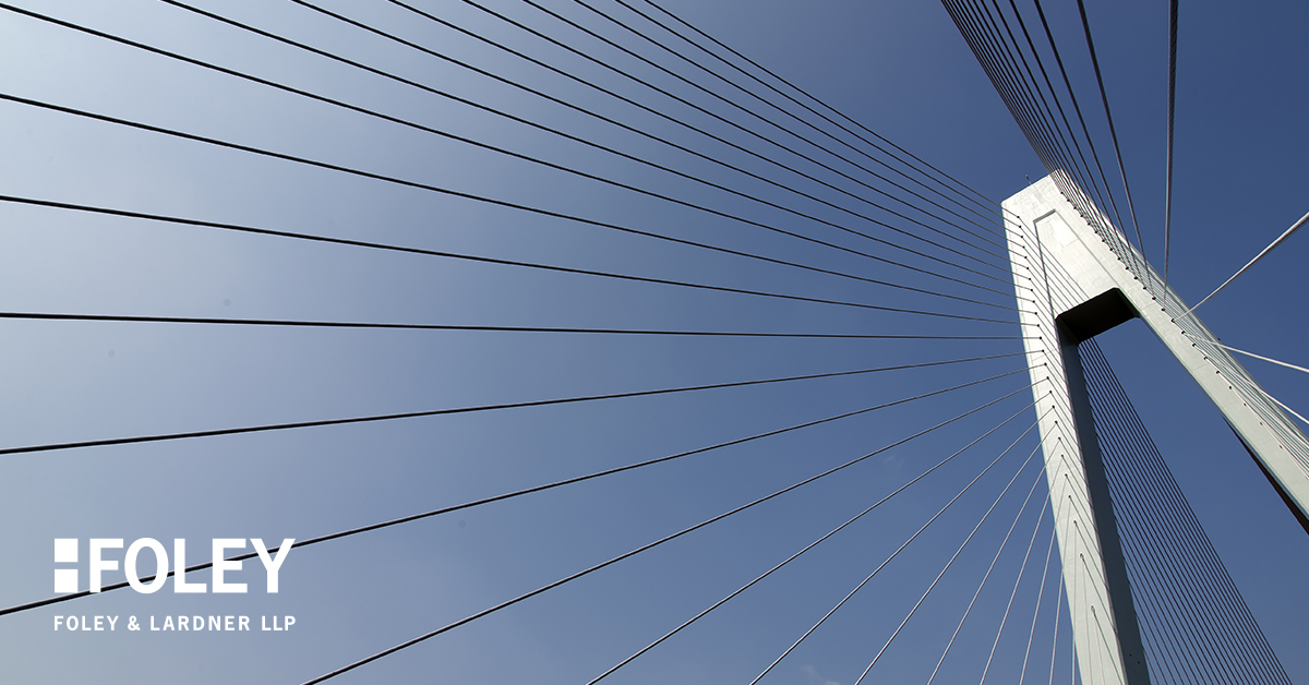Upward view of a modern cable-stayed bridge pylon against a clear blue sky, with the Foley & Lardner LLP logo in the lower left corner—highlighting trusted law offices and litigation support.