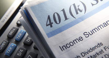 Close-up of a 401(k) statement titled "Income Summary," with part of a calculator visible in the background, commonly referenced by Chicago lawyers for litigation support and financial reviews.