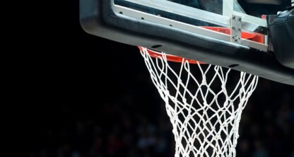 A close-up of a basketball hoop and net against a dark background, with part of the backboard visible at the top—much like the sharp focus required by top lawyers in Chicago.