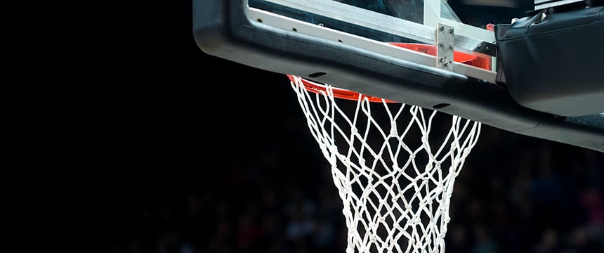 A close-up of a basketball hoop and net against a dark background, with part of the backboard visible at the top—much like the sharp focus required by top lawyers in Chicago.
