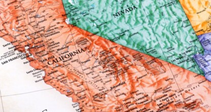 A close-up of a physical map showing parts of California and Nevada, with cities, terrain features, and state borders labeled—ideal for law offices or firms seeking detailed visuals for litigation support.
