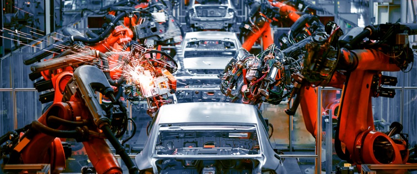 Assembly line with robotic arms welding and assembling car bodies in an automotive factory, highlighting innovations that often require protection under intellectual property law.