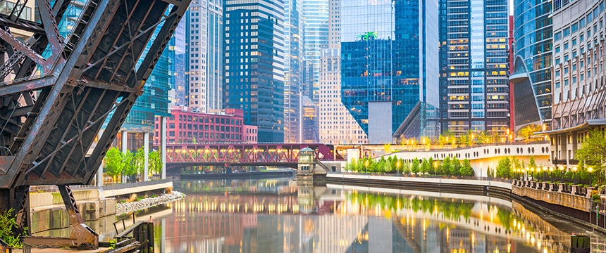 Downtown cityscape with modern high-rise buildings, a raised drawbridge, and a river reflecting the architecture—an iconic view often seen near top chicago lawyers’ offices on a cloudy day.