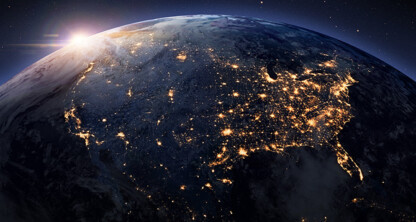 A view of North America from space at night, city lights shining as the sun rises on the horizon—an inspiring sight for lawyers in Chicago working late in bustling law offices.