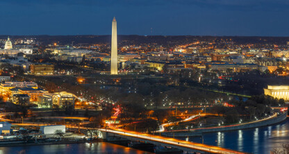 A panoramic nighttime view of Washington, D.C. featuring the illuminated Washington Monument, U.S. Capitol, and Lincoln Memorial—an inspiring scene for those practicing intellectual property law amid city lights and historic landmarks.