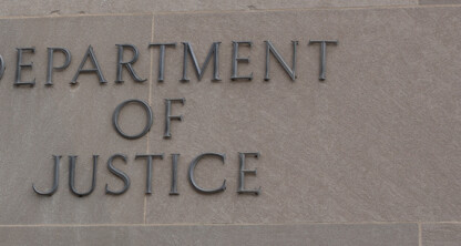 Text reading "Department of Justice" displayed on a stone wall, symbolizing the authority that guides lawyers in Chicago and protects key fields such as intellectual property law.