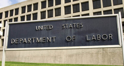 Large sign reading "United States Department of Labor" in front of a government office building with rows of windows, where chicago lawyers often navigate complex cases like intellectual property law.