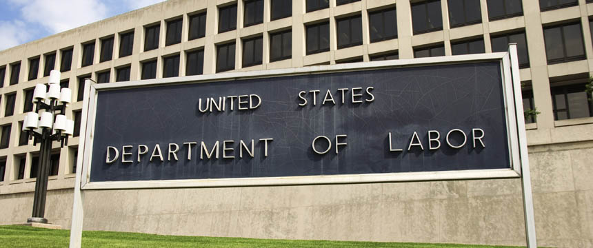 Large sign reading "United States Department of Labor" in front of a government office building with rows of windows, where chicago lawyers often navigate complex cases like intellectual property law.