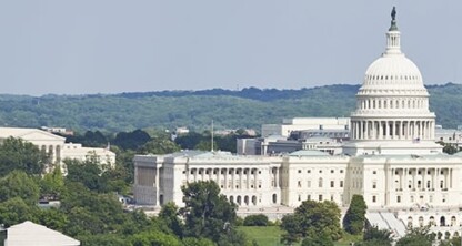 The United States Capitol building is seen in the center of the image, surrounded by trees and other government buildings, much like how law offices or intellectual property law firms anchor cityscapes under a clear sky.