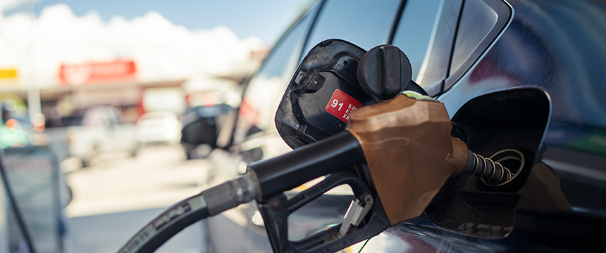 Close-up of a gasoline pump nozzle inserted into a car’s fuel tank at a gas station, with a focus on the 91 octane fuel label—similar attention to detail you'd expect from top law offices or lawyers in Chicago.