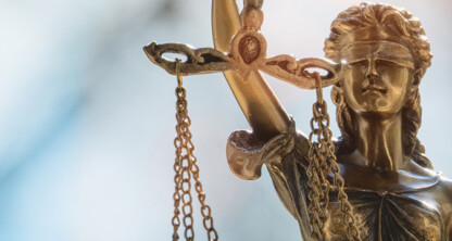 Close-up of a bronze Lady Justice statue holding balanced scales, her eyes covered by a blindfold—a timeless symbol often found in law offices, representing fairness and impartiality in litigation support.