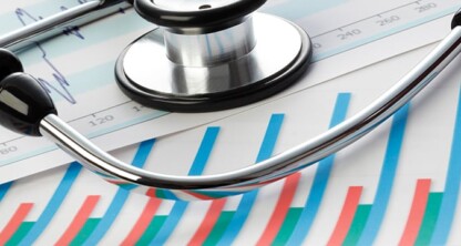 A stethoscope lies on top of printed charts and graphs displaying statistical and medical data, symbolizing the intersection of healthcare and intellectual property law.