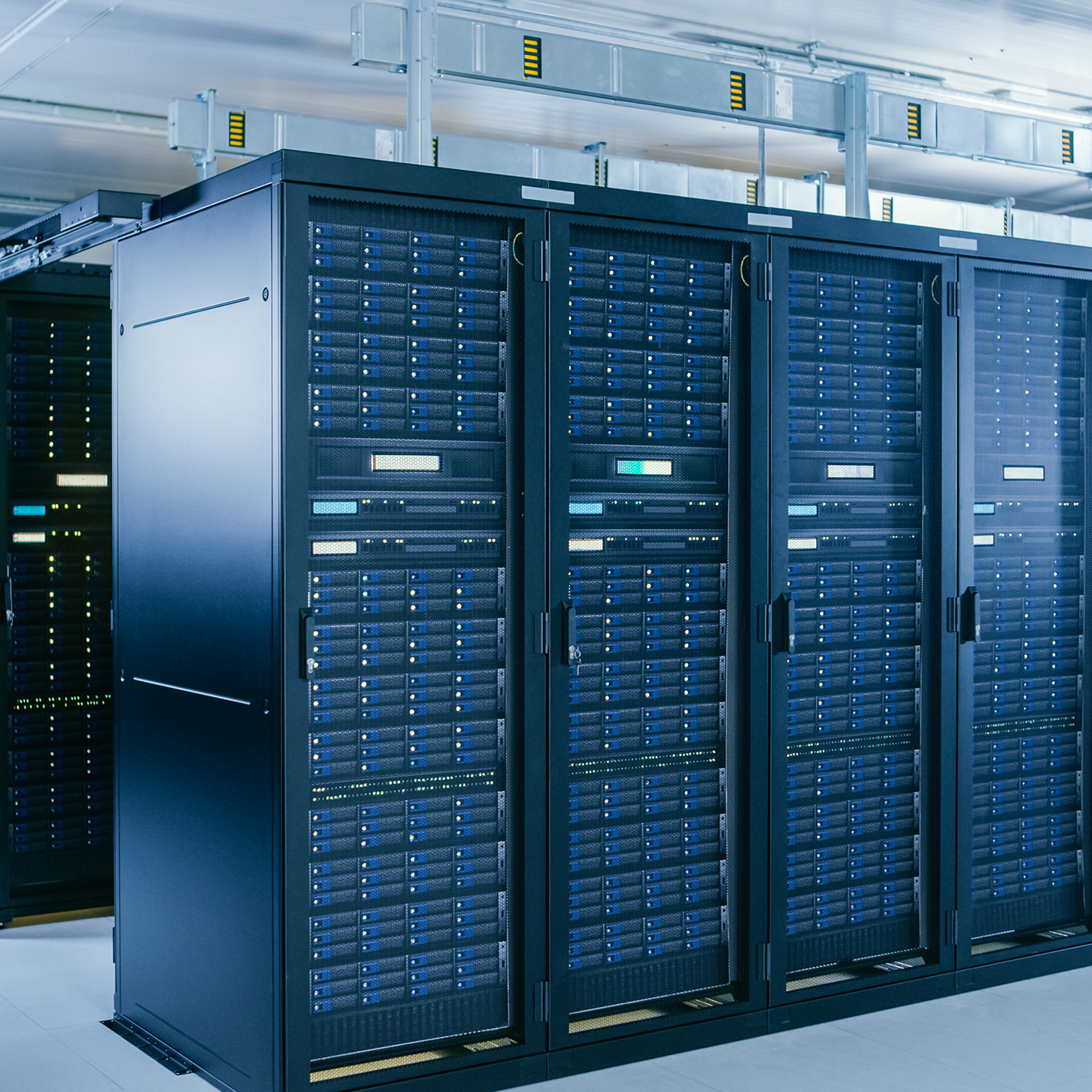 Rows of black server racks with blue indicator lights in a modern data center, supporting the secure digital infrastructure relied upon by today’s leading law offices and corporate law firms.
