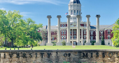 The University of Missouri campus with a view of the historic red-brick building, iconic columns, and clear blue sky—an inspiring backdrop for those pursuing careers in intellectual property law.