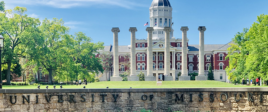 The University of Missouri campus with a view of the historic red-brick building, iconic columns, and clear blue sky—an inspiring backdrop for those pursuing careers in intellectual property law.