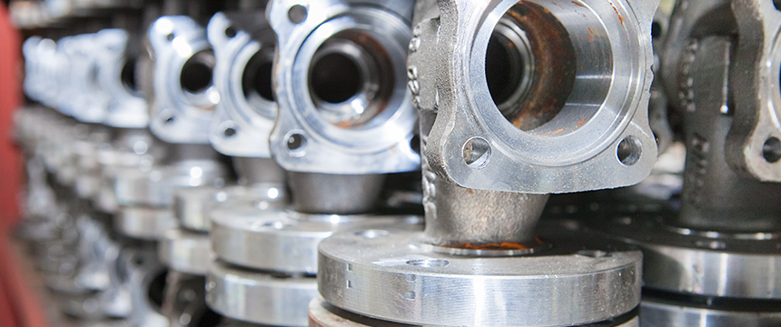 Close-up view of several metal valve components arranged in rows, their circular openings and polished surfaces reflecting precision—much like the meticulous attention given by Chicago lawyers at a corporate law office.