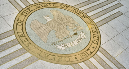 The Great Seal of the State of New Mexico, dated 1912, displayed on a stone floor with an eagle and the motto "Crescit Eundo," offers inspiration to chicago lawyers and those in intellectual property law.