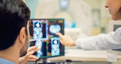 Two healthcare professionals examine and discuss medical scans displayed on computer monitors in a clinical setting, providing valuable insights often utilized by Chicago lawyers for litigation support.