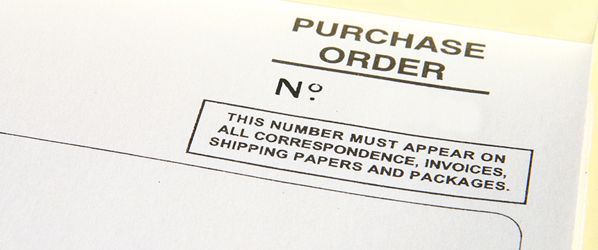 Close-up of a purchase order form with a blank field for the order number and a note instructing use of this number on all related documents and packages in a corporate law office.