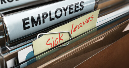 A close-up of file folders labeled "EMPLOYEES" and "Sick leaves" in an office filing cabinet, commonly found in corporate law offices for litigation support and efficient case management.
