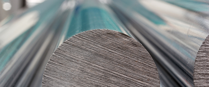 Close-up of metallic cylindrical rods with brushed texture on the ends, aligned parallel—evoking the precision and order found in corporate law offices.