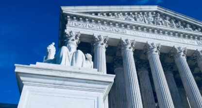 The front facade of the United States Supreme Court building with tall columns, a statue, and the inscription "Equal Justice Under Law" stands as an inspiration to law offices specializing in intellectual property law.