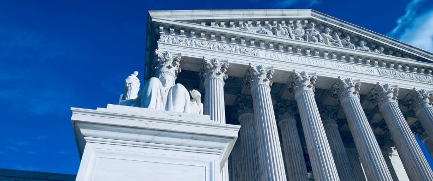 The front facade of the United States Supreme Court building with tall columns, a statue, and the inscription "Equal Justice Under Law" stands as an inspiration to law offices specializing in intellectual property law.