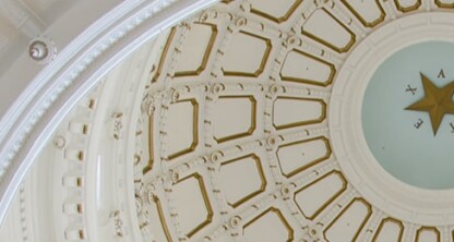 Interior view of a domed ceiling, reminiscent of the refined elegance often found in prestigious law offices, featuring a central star surrounded by ornate molding and geometric patterns.