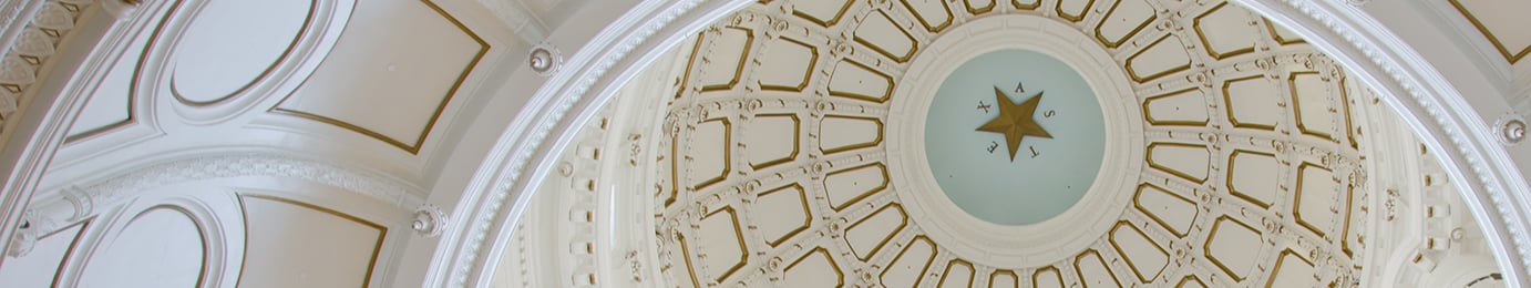 Interior view of a domed ceiling, reminiscent of the refined elegance often found in prestigious law offices, featuring a central star surrounded by ornate molding and geometric patterns.