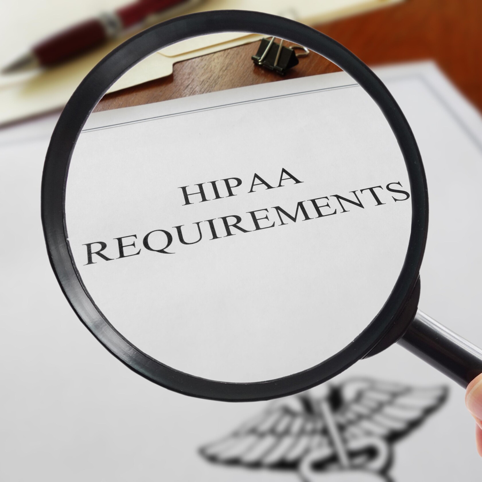 A magnifying glass focuses on a document titled "HIPAA REQUIREMENTS," with a blurred medical symbol and a pen visible in the background, evoking the precision of corporate law office practices among top Chicago lawyers.