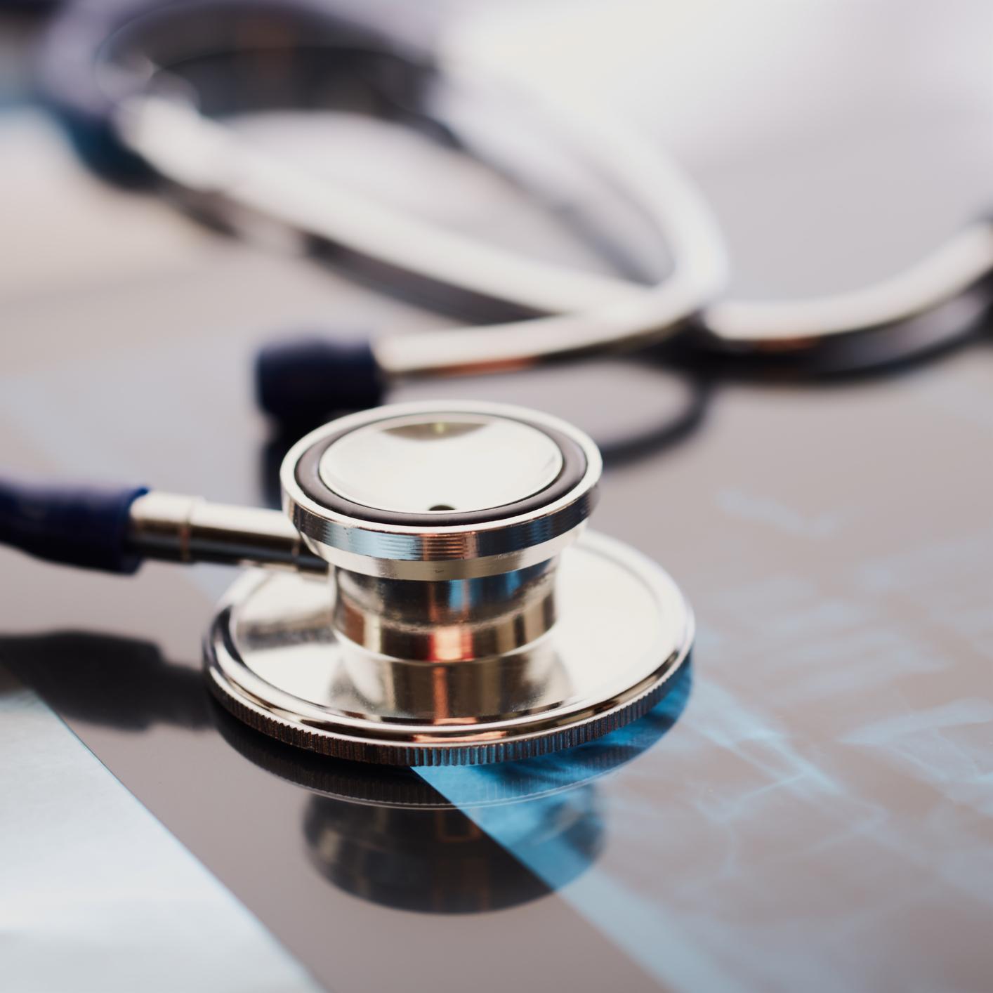 A stethoscope rests on top of an X-ray film, symbolizing medical examination and healthcare diagnostics—an image reflecting the precision valued by chicago lawyers and corporate law offices in litigation support.