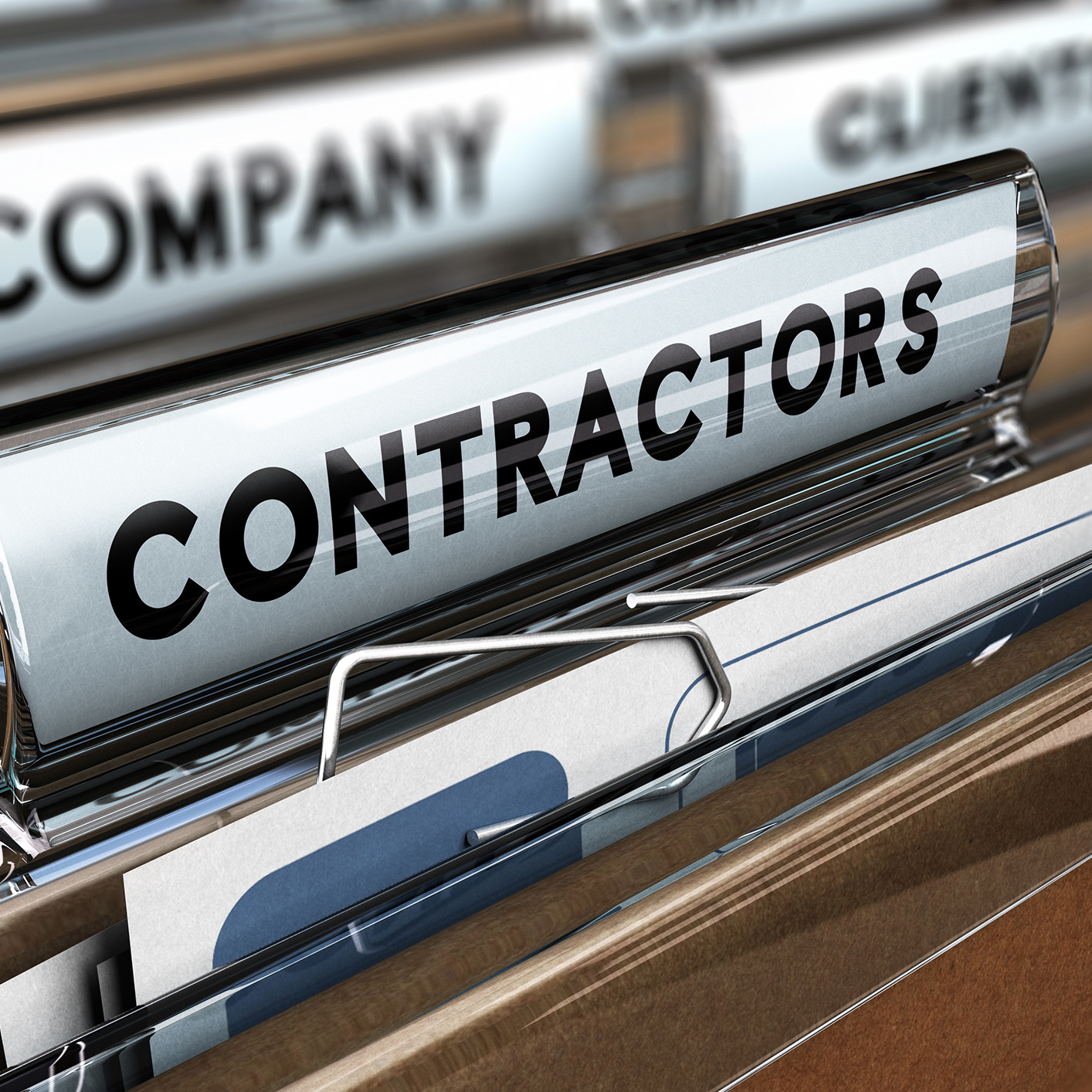 A file folder labeled “CONTRACTORS” sits in a filing cabinet among other labeled folders, often used by lawyers in Chicago for litigation support and managing intellectual property law documents.