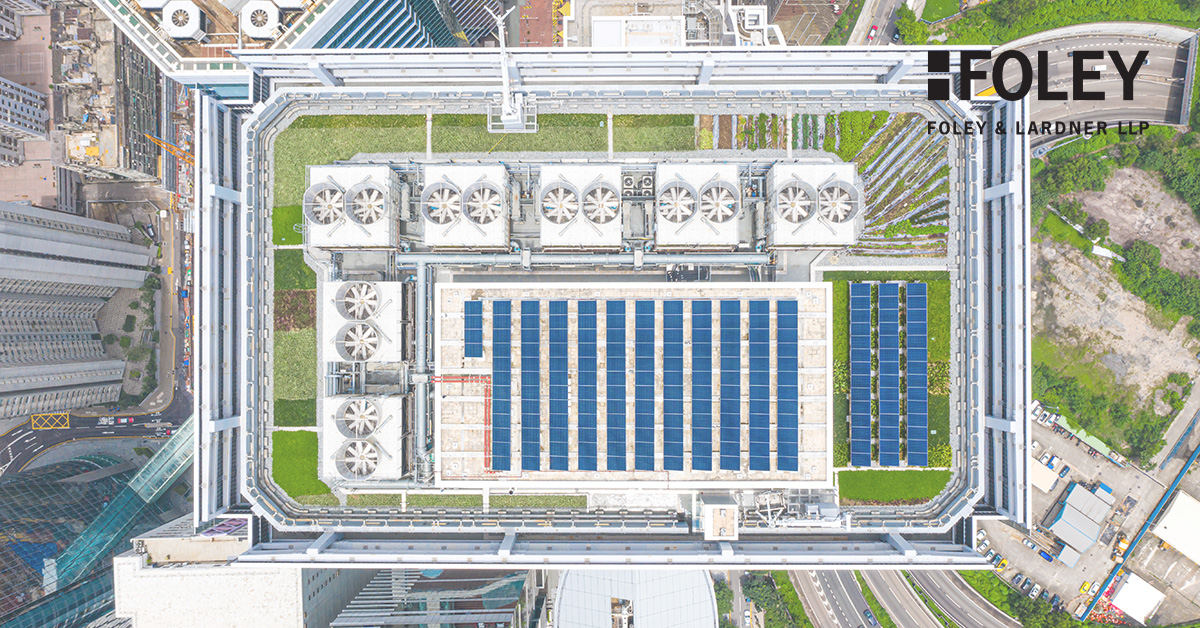 Aerial view of a rooftop with solar panels, green spaces, and cooling units on a building in an urban area; Foley & Lardner LLP logo in the top right corner, highlighting innovative law offices and lawyers in Chicago.