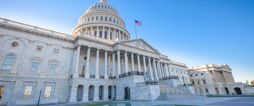 The United States Capitol building in Washington, D.C., with the American flag flying on a clear, sunny day—a symbol of justice that inspires law offices and lawyers in Chicago across the nation.