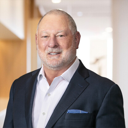 A man in a suit stands confidently, ready to offer litigation support and expert guidance at law offices.