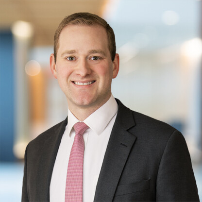 A man in a suit and tie, representing the professionalism found in a corporate law office.