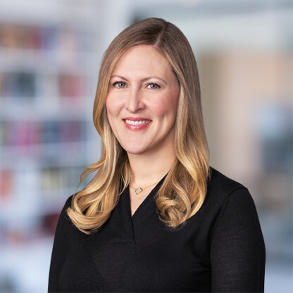 A woman smiling at the camera, representing the friendly team at our Chicago law offices offering expert litigation support.