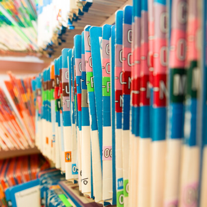 Rows of color-coded file folders are organized and stored vertically on shelves, commonly seen in law offices or litigation support rooms for efficient document management.