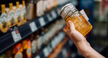 A person holding a jar of liquid, reminiscent of the meticulous care seen in top corporate law offices or among skilled lawyers in Chicago.