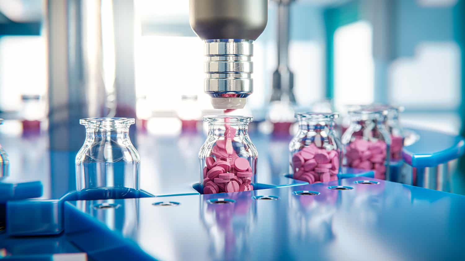 A machine dispenses pink tablets into glass vials on an automated pharmaceutical production line, providing precision and reliability ideal for litigation support or compliance needs of a corporate law office.