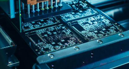 Close-up view of an automated machine assembling and testing circuit boards in an electronics manufacturing process, offering advanced solutions that can benefit lawyers in Chicago seeking reliable litigation support technology.